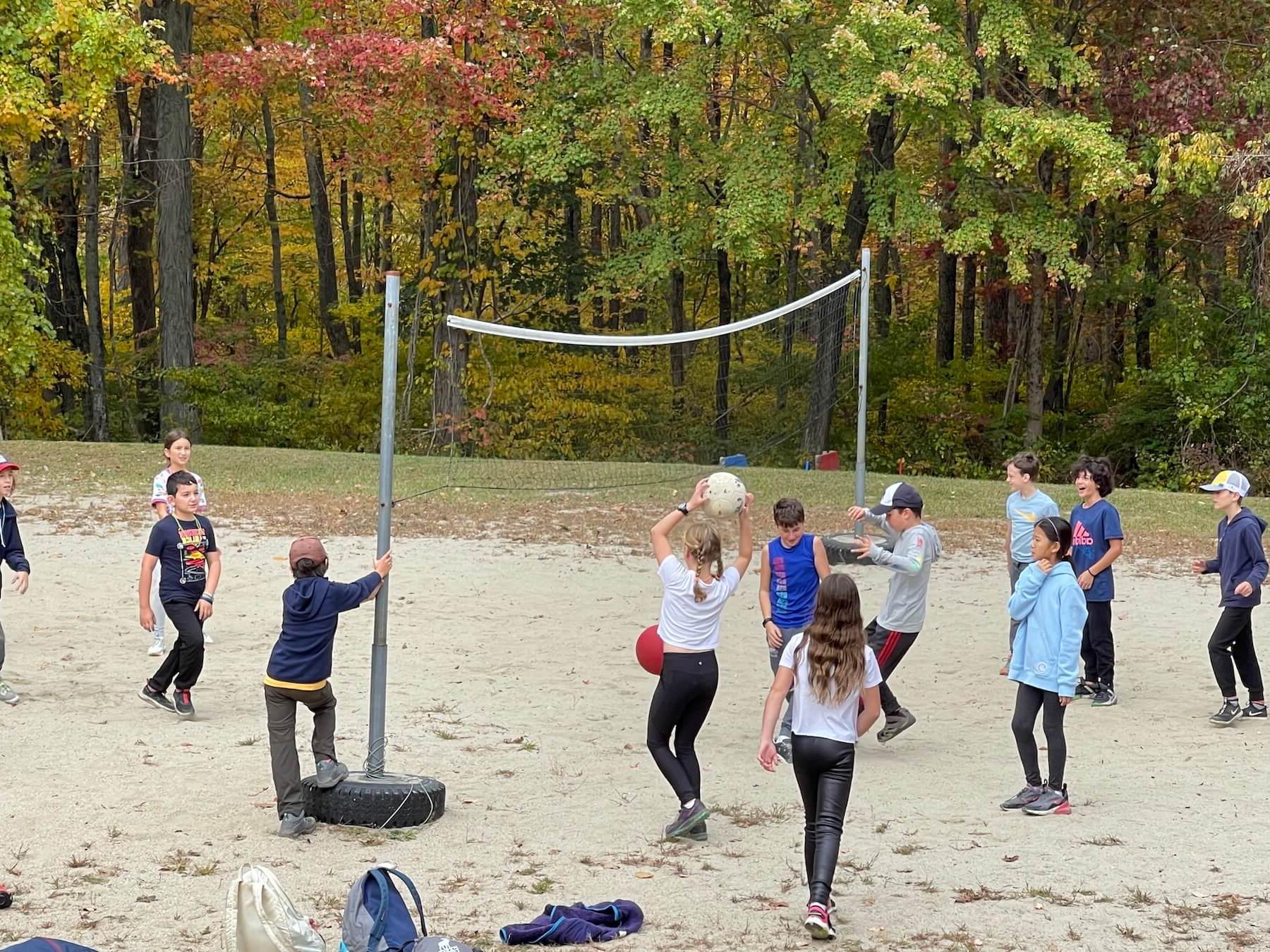 Ethical Culture's 5th Graders play beach volleyball outside.