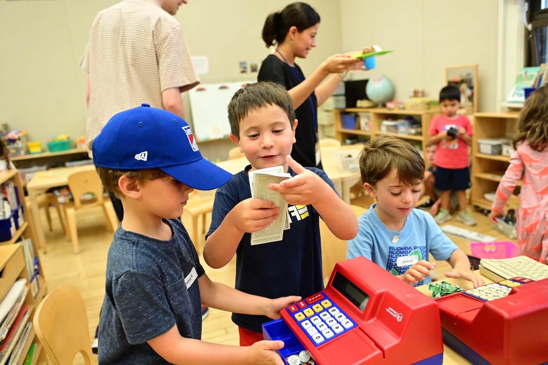 Ethical Culture Fieldston School Ethical Culture students share play money in class
