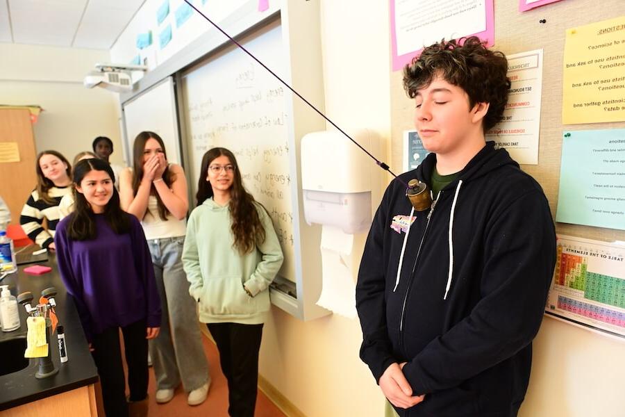菲尔德斯顿中学中学生在科学课上用钟摆做实验