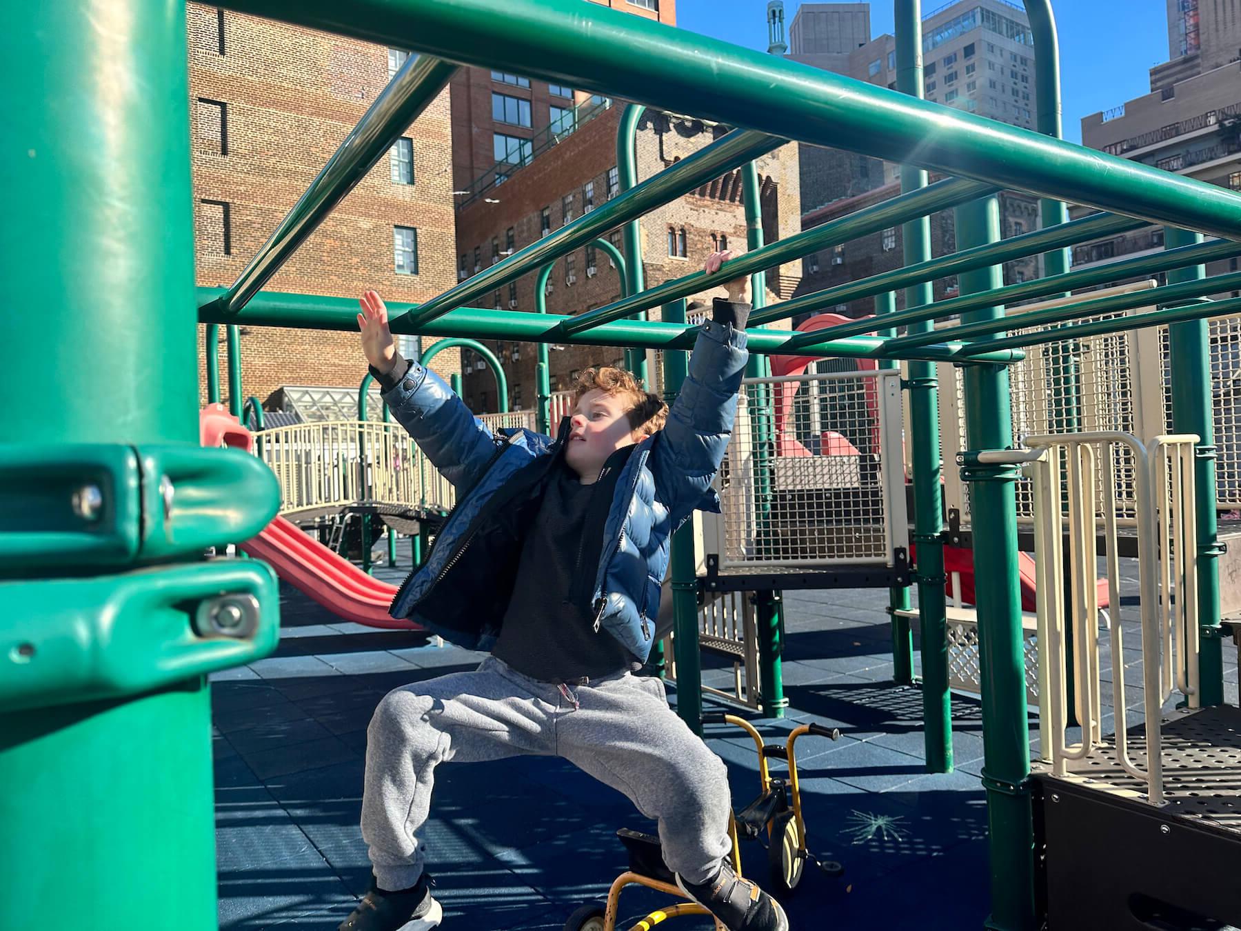 Ethical Culture Fieldston School student swings from bars on the Ethical Culture roof