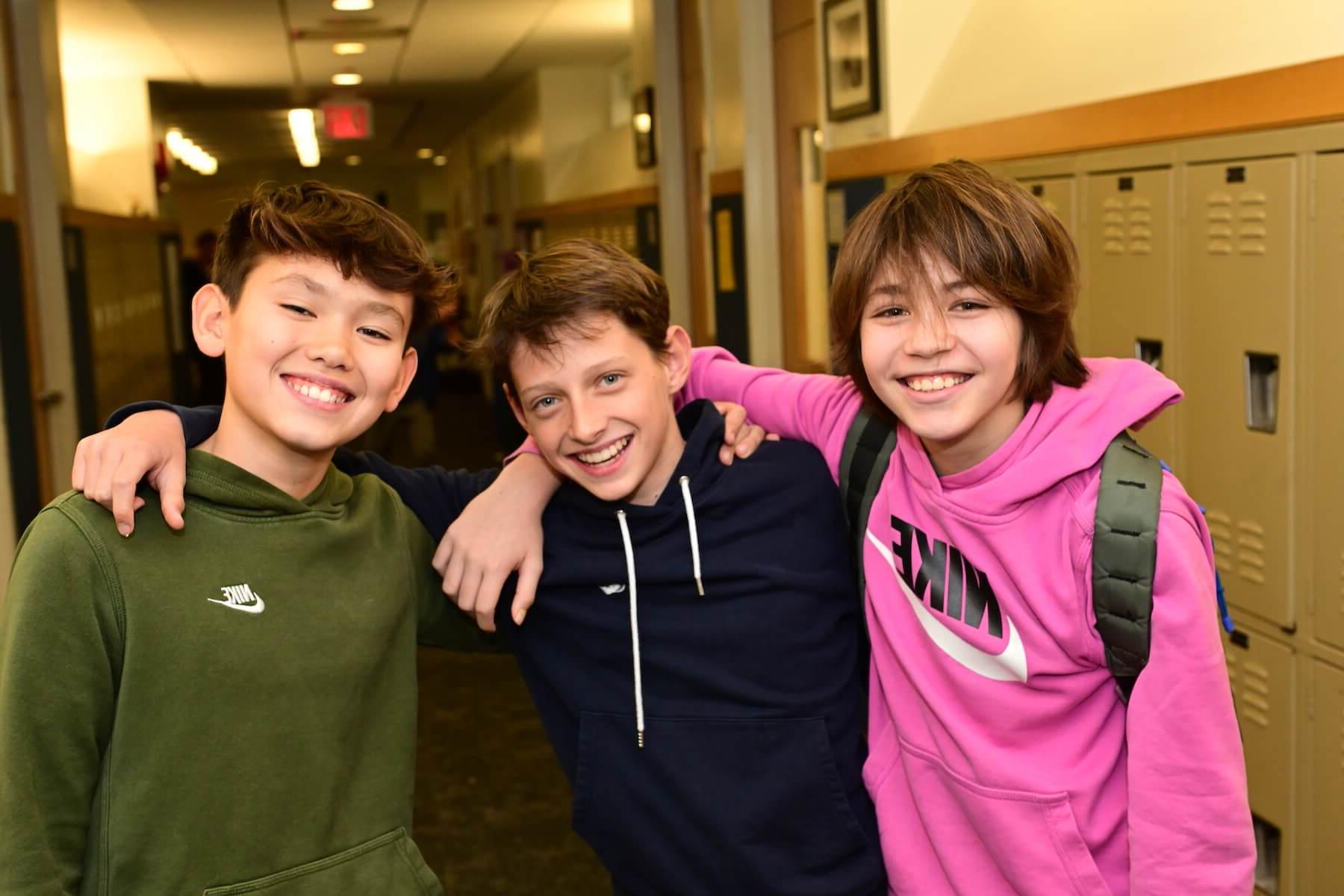 Ethical Culture Fieldston School students in Fieldston Middle smiling at the camera