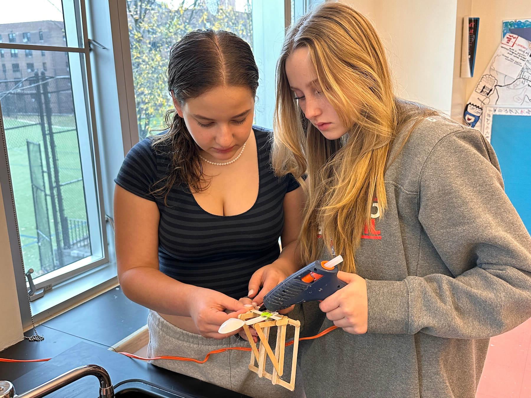 Ethical Culture Fieldston School students in Fieldston Middle building an experiment in science class