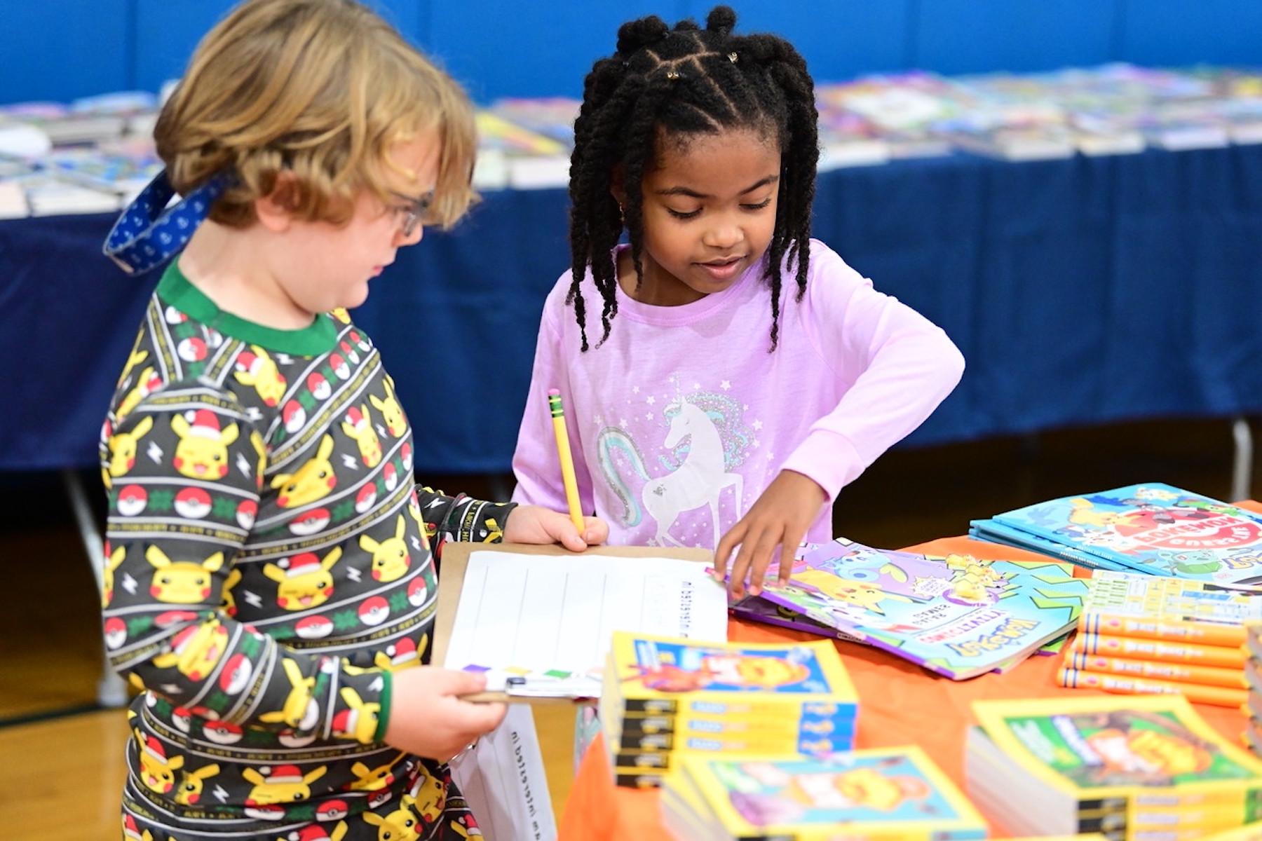 Two students at Fieldston Lower browse for books at the ECFS Celebration of Books.