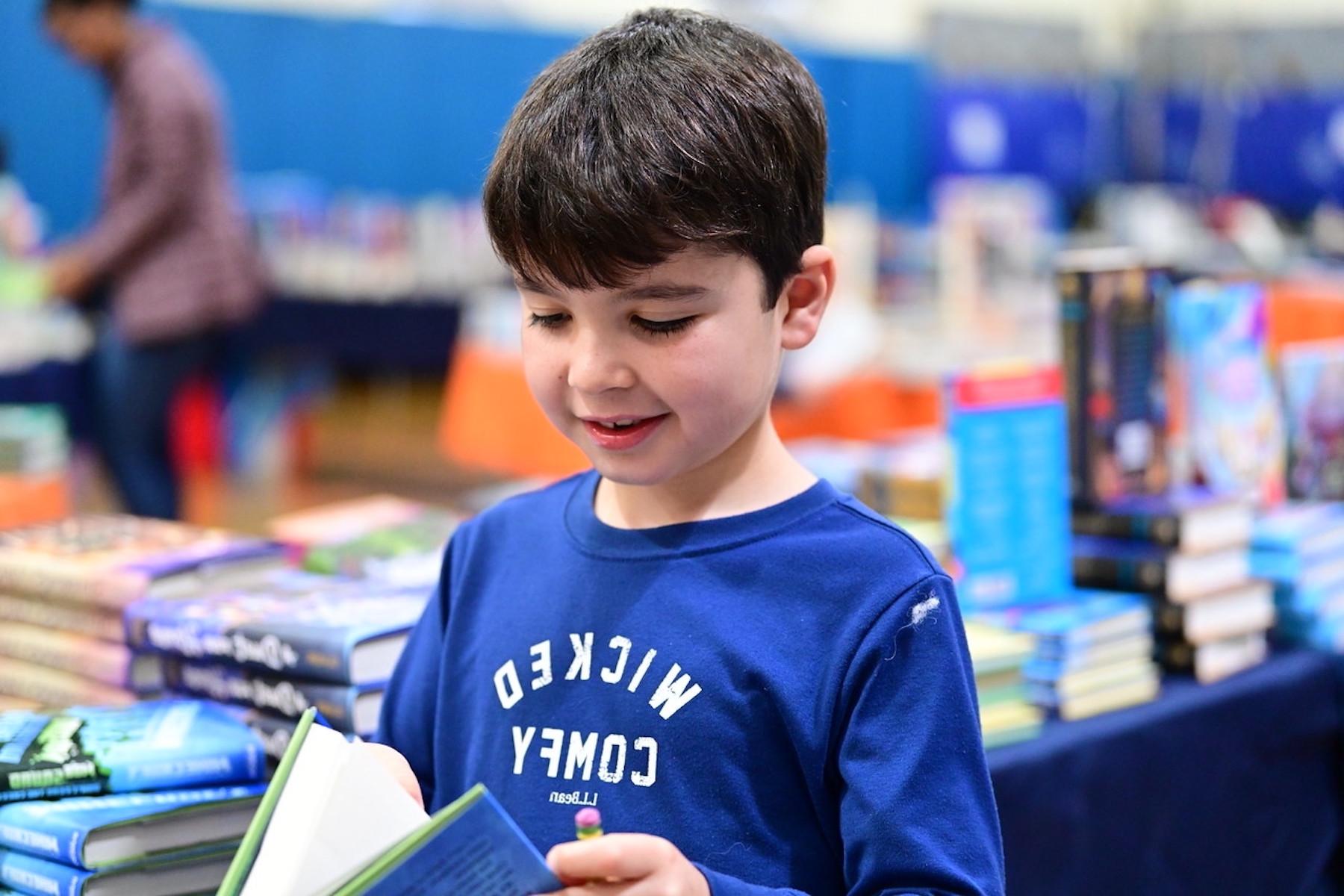 Student at Fieldston Lower browses for books at the ECFS Celebration of Books.